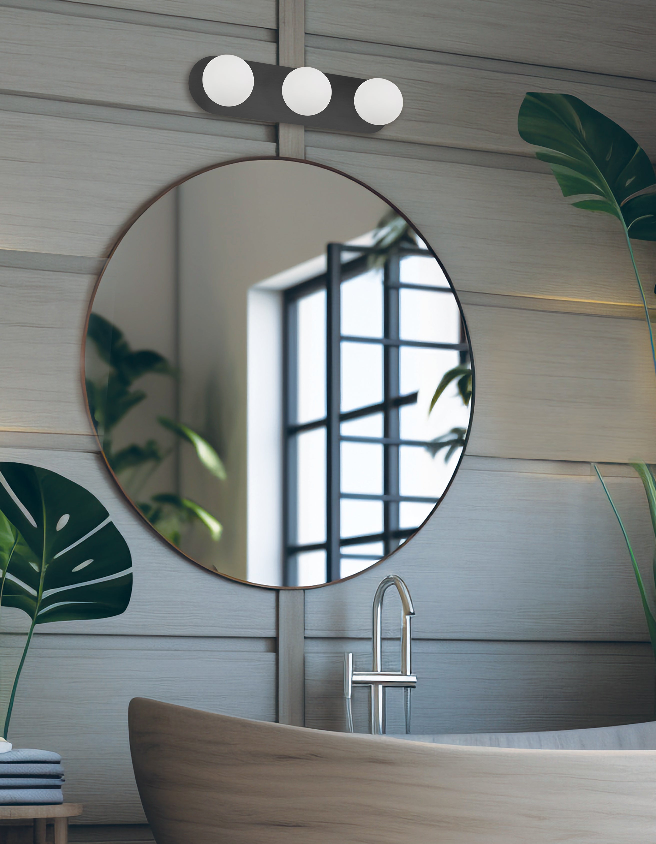 Round mirror above a bathtub with a modern design