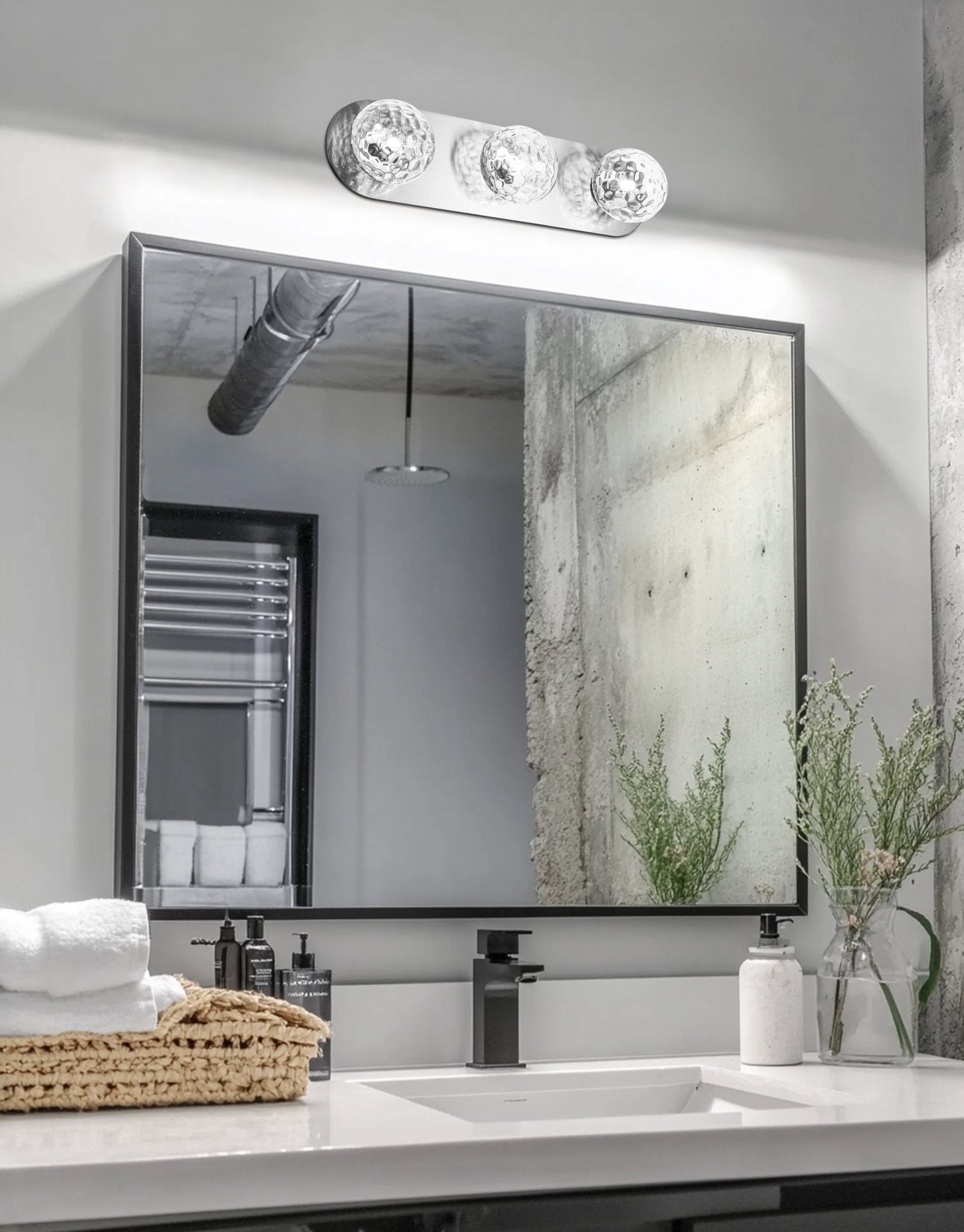 Bathroom vanity with mirror, sink, and decorative elements.