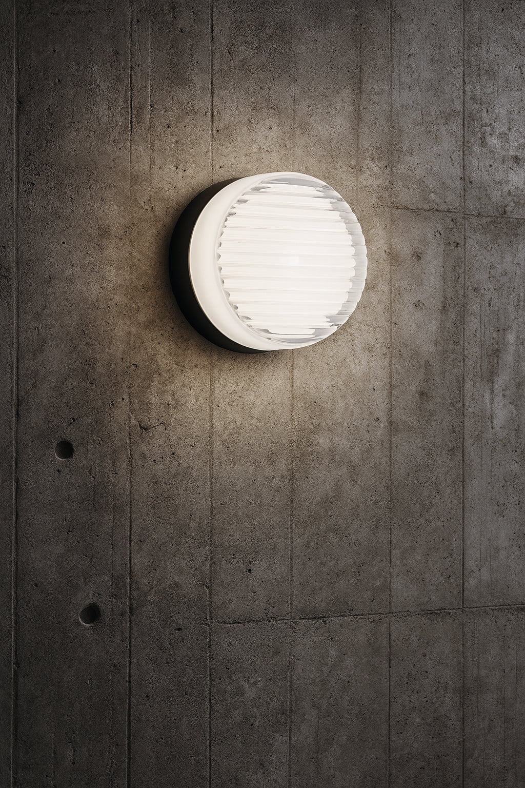 Round wall light fixture on a concrete wall