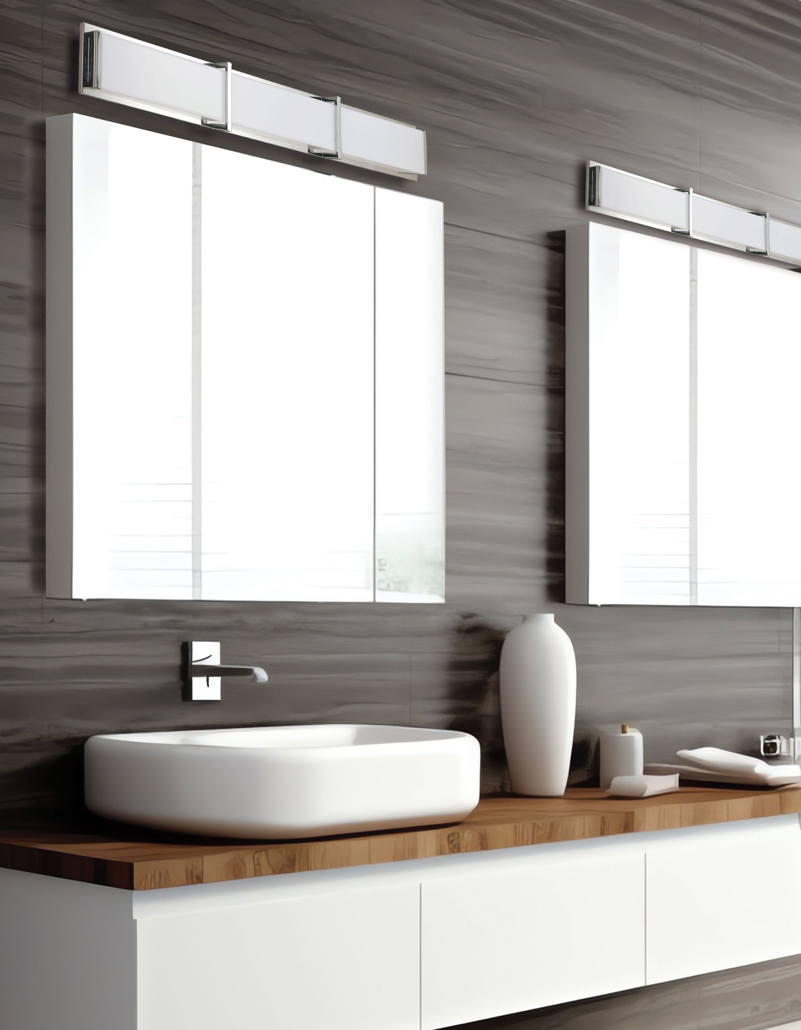Modern bathroom with a sink, mirror, and decorative items.