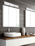 Modern bathroom with a sink, mirror, and decorative items.
