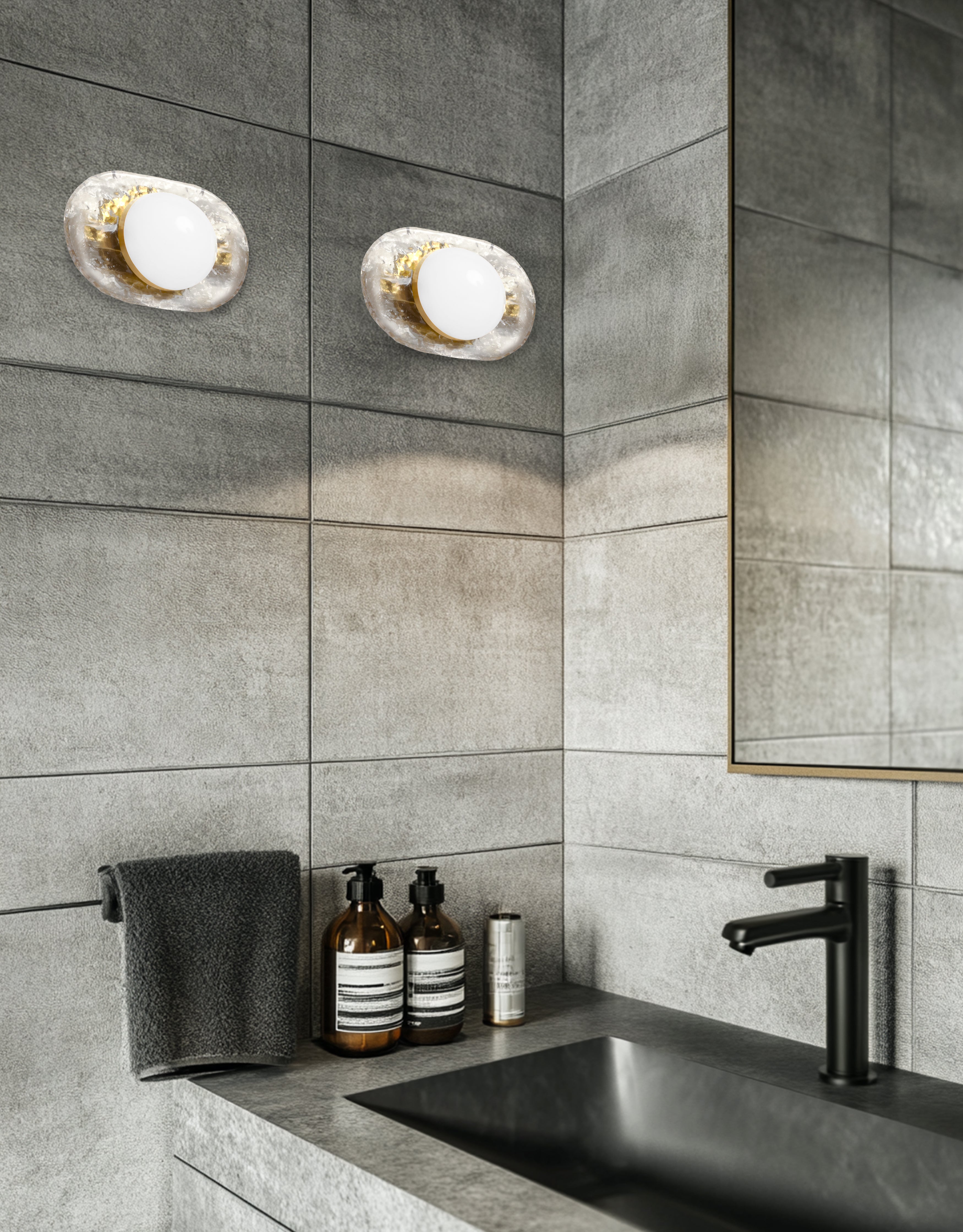 Modern bathroom with gray tiles, a sink, and decorative bottles.