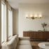 Modern living room with beige sofa, wooden cabinet, and wall sconce.