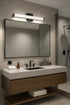 Modern bathroom vanity with mirror, sink, and lighting fixture.