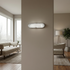 Modern wall light fixture in a living room setting with neutral tones.